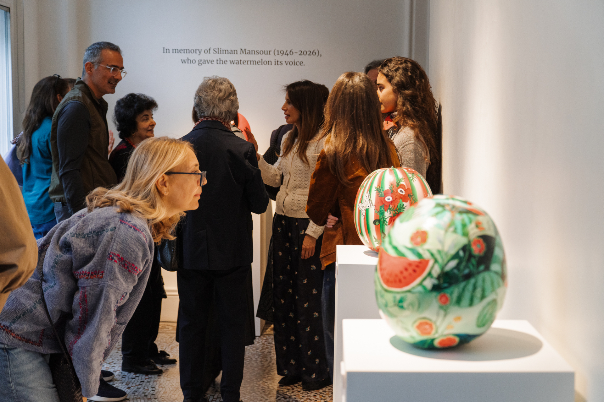 Guests gathered around the Mansour tribute wall at Bateekha, Gallery 1957, London